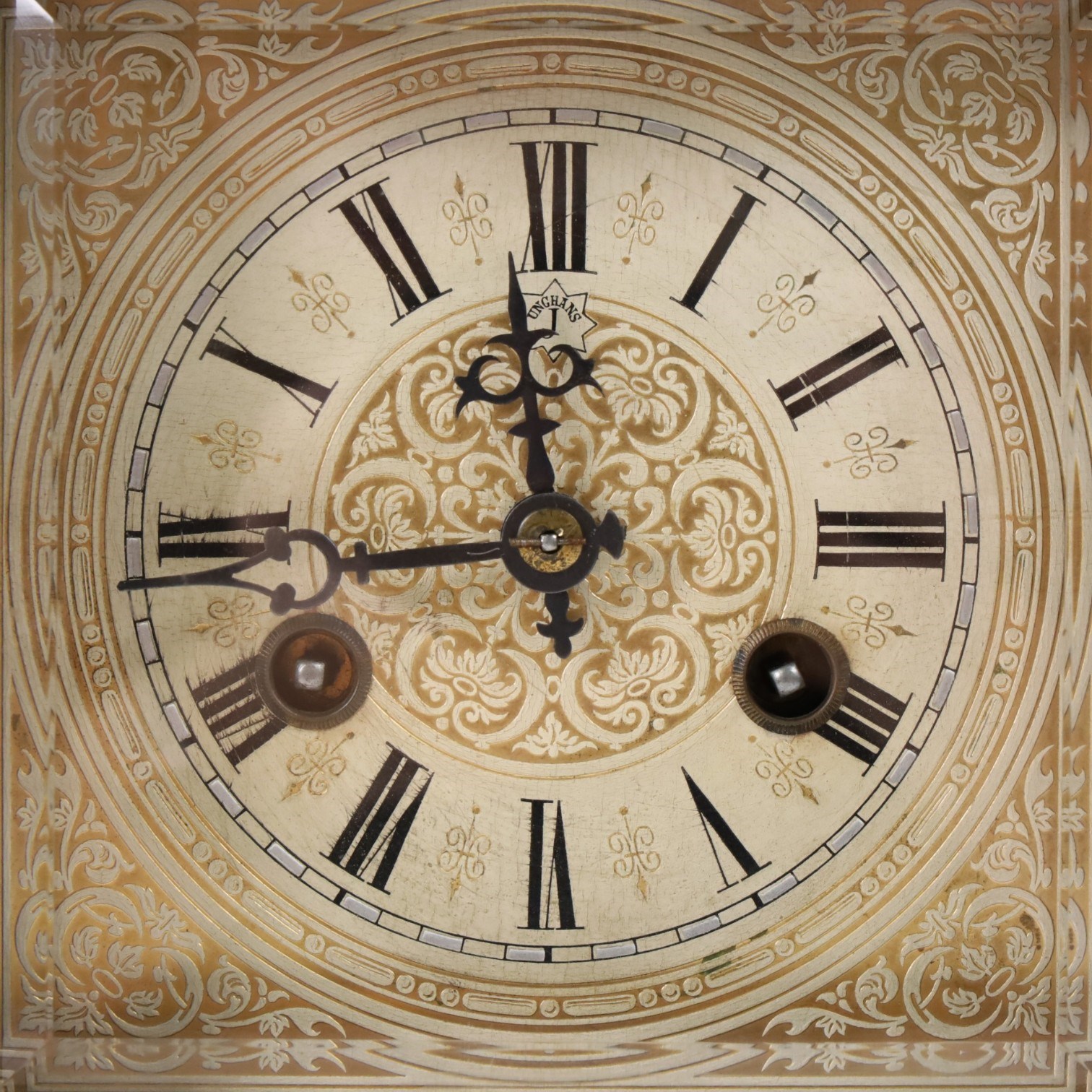 Junhgans eight-day cased mantle clock, with a square etched dial and Roman Numerals, a carved ogee pediment and turned finials, on a broad blinth with bun feet, H49cm