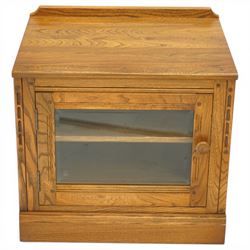 Ercol - elm media cabinet of small proportions, fitted with glazed door enclosing single shelf, on skirted base