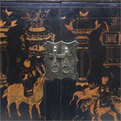 19th century Chinese black lacquer marriage cabinet, rectangular form, twin cupboard doors painted with gilt chinoiserie scenes depicting mounted figures, ritual urns and symbolic objects within patterned borders, central shaped metal lock plate with twin drop handles, lower section decorated with fruiting sprays, standing on stile supports
