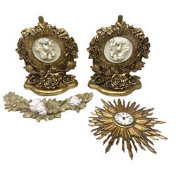 Pair of gilt wall brackets with composite relief in the centre, together with a gilt wall clock and a similar wall hanging