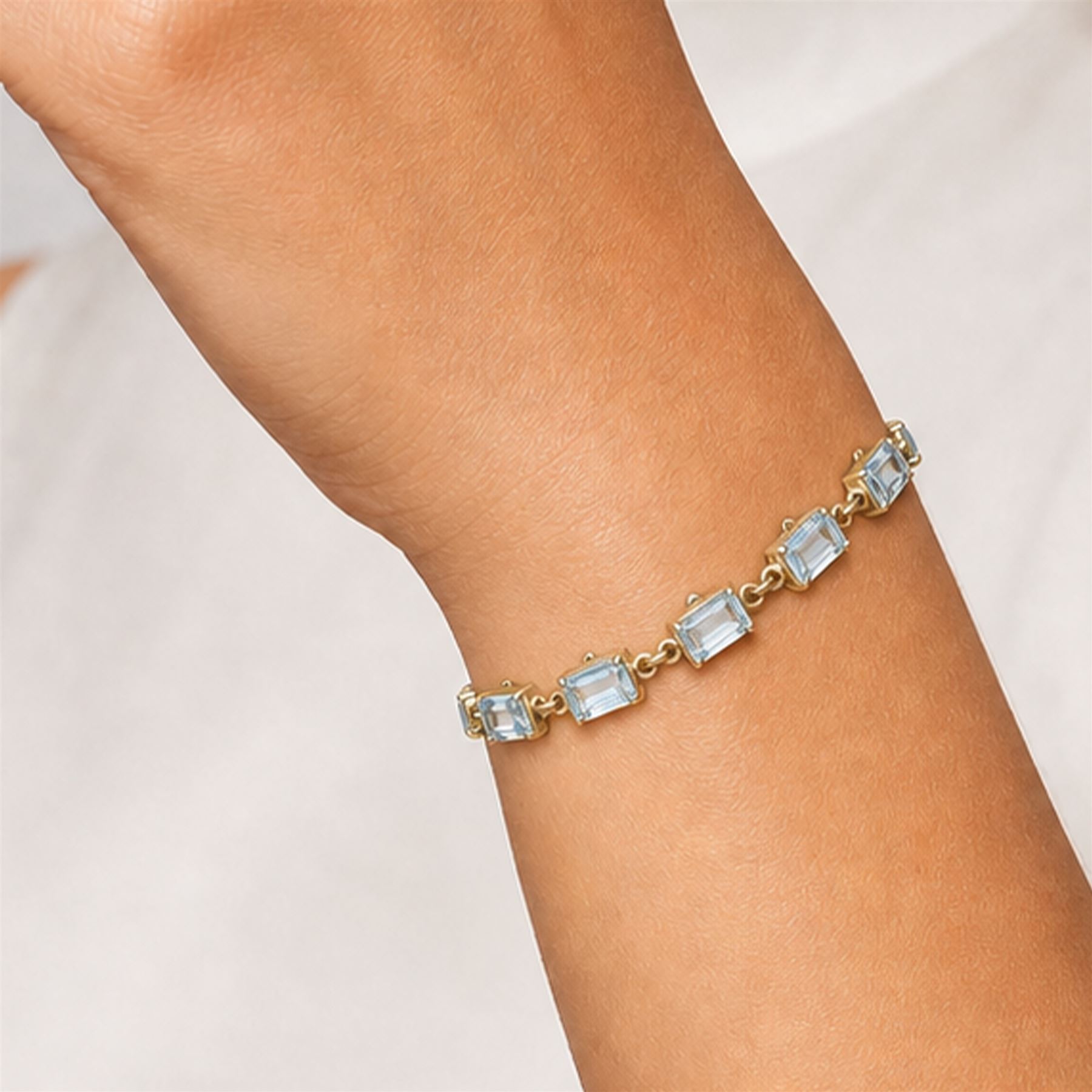 9ct gold Swiss blue topaz bracelet, set with thirteen rectangular cut topaz's, hallmarked