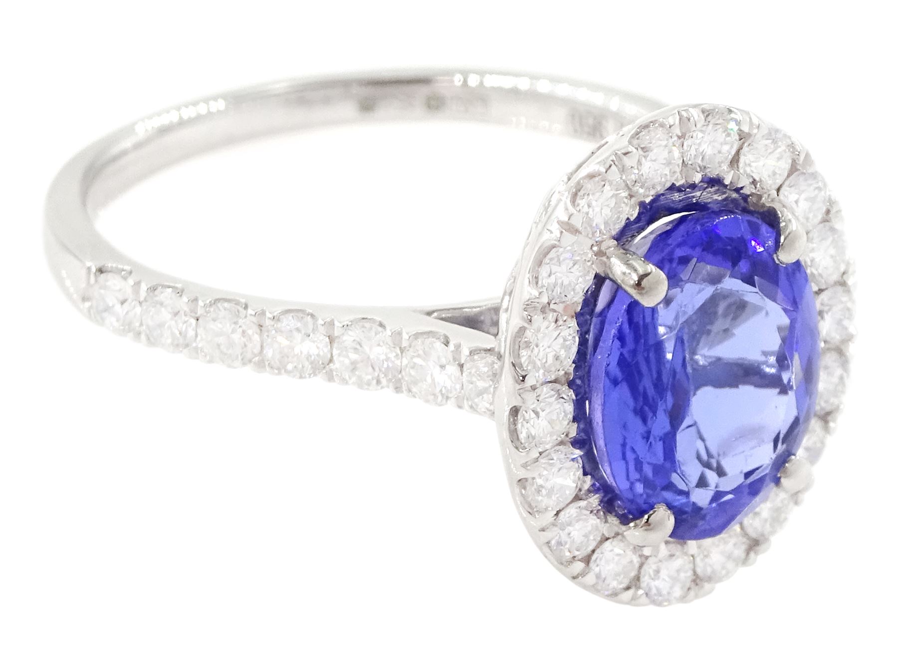 Platinum tanzanite and diamond cluster ring, single oval tanzanite of 2.36 carat, with round brilliant cut diamond surround and diamond set shoulders, hallmarked, total diamond weight 0.76 carat, with World Gemological Institute report