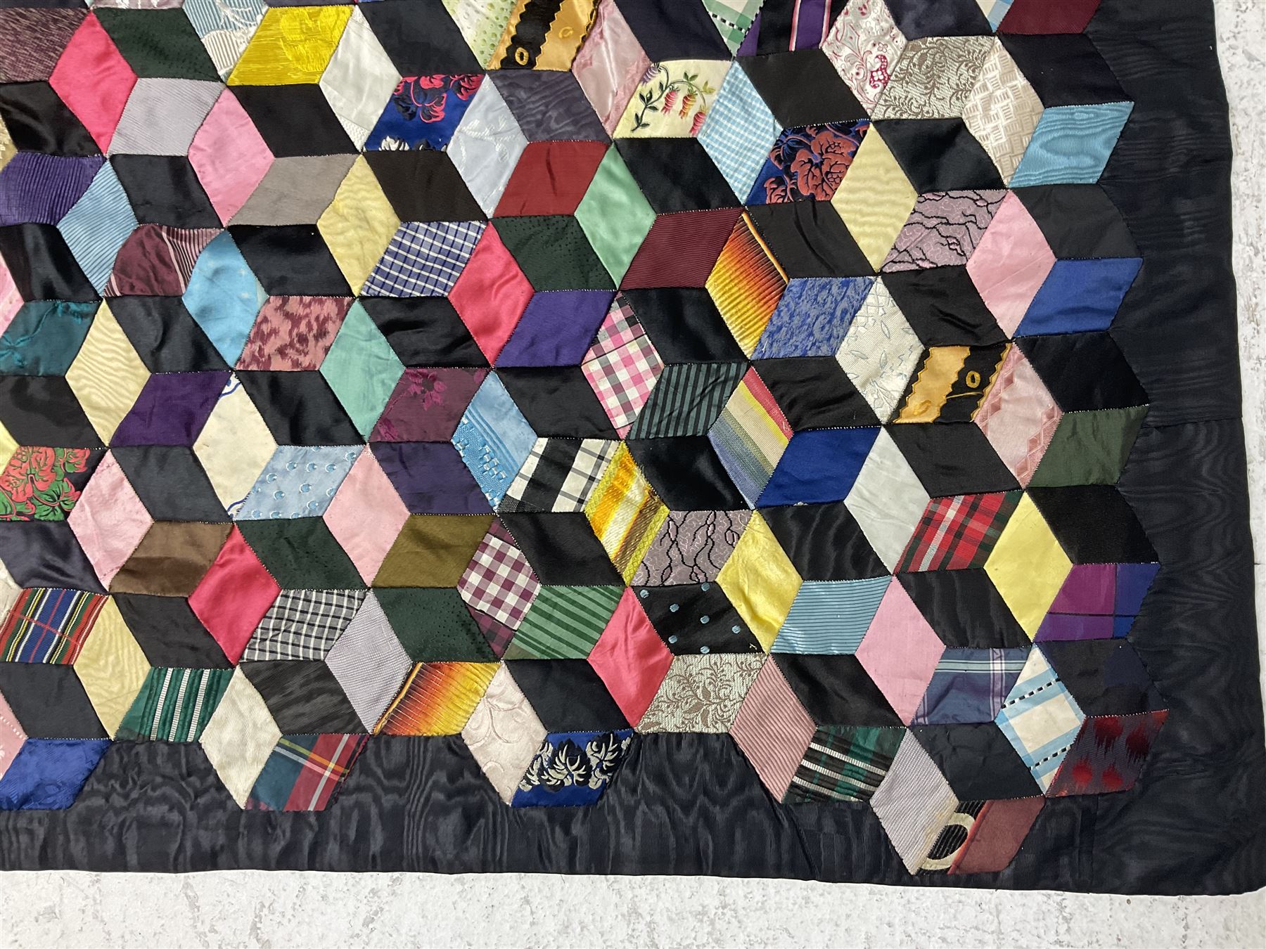 19th Century silk and satin tumbling blocks pattern patchwork quilt with black border 228cm X 196cm