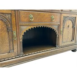 Edwardian oak sideboard, raised arcade carved back over rectangular top, fitted with four drawers, two arch carved doors doors flanking open arched centre, on turned feet