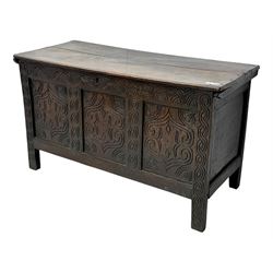English carved oak coffer, hinged rectangular lid with indented side edges, internal candle-box, front with three-panel front with decorative carvings, raised on stile feet, circa 1700