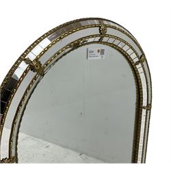 Arched top cushion framed wall mirror, decorated with gilt metal beading 