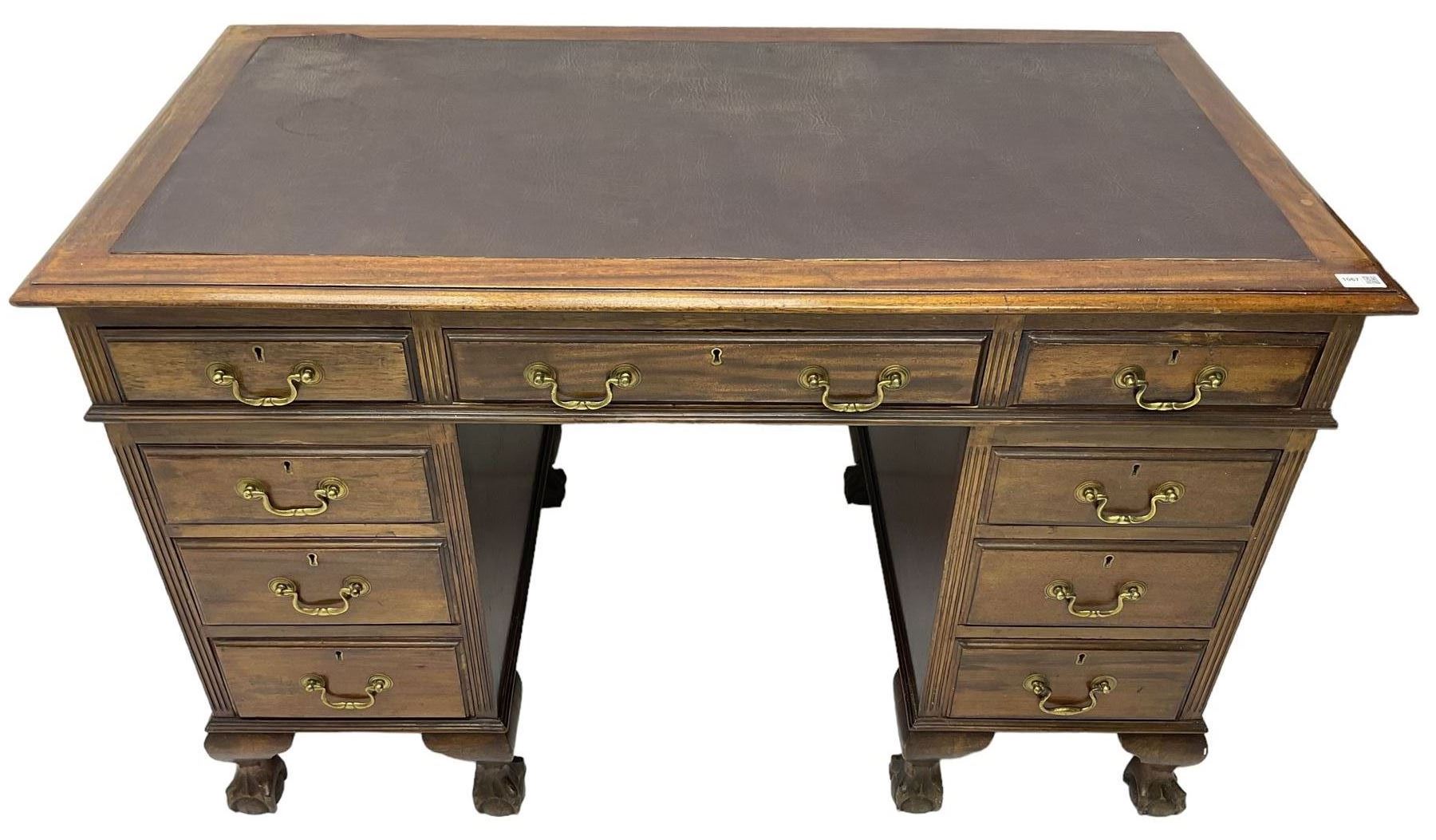 Early 20th century mahogany twin pedestal desk, fitted with nine drawers, on ball and claw carved cabriole feet