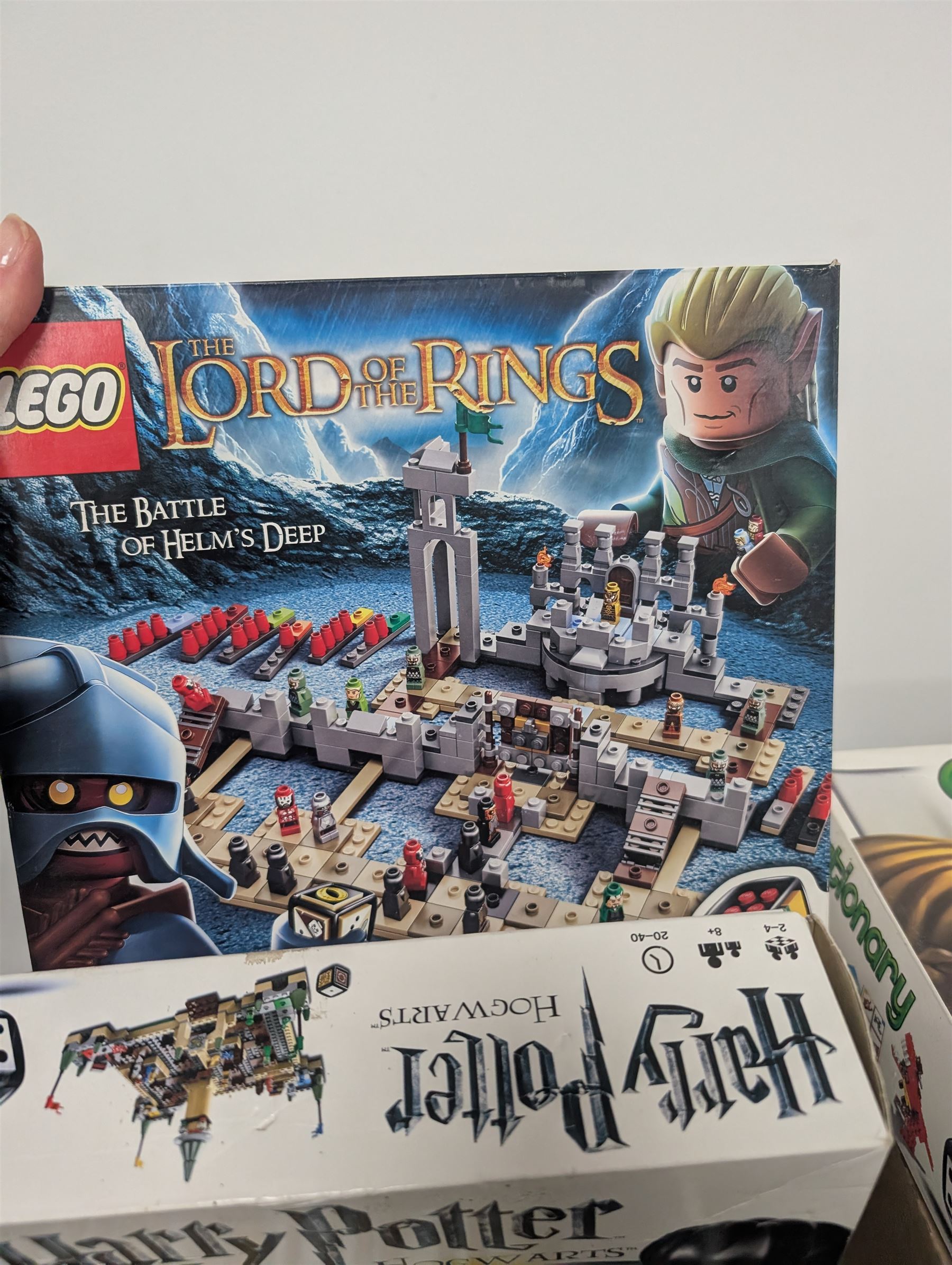 Collection of Lego Games sets, including no. 3841 Minotaurus, 3862 Harry Potter Hogwarts, 50011 Lord of the Rings Battle of Helms Deep, 3860 Heroica Fortaan, 3848 Pirate Plank, 3855 Ramses Return, 3844 Creationary, etc