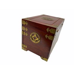 Chinese hardwood jewellery box mounted with engraved brass fixtures, the two exterior doors revealing three drawers below the hinged upper lid, lined with red material decorated with floral sprays, H25cm, W36cm, D23cm