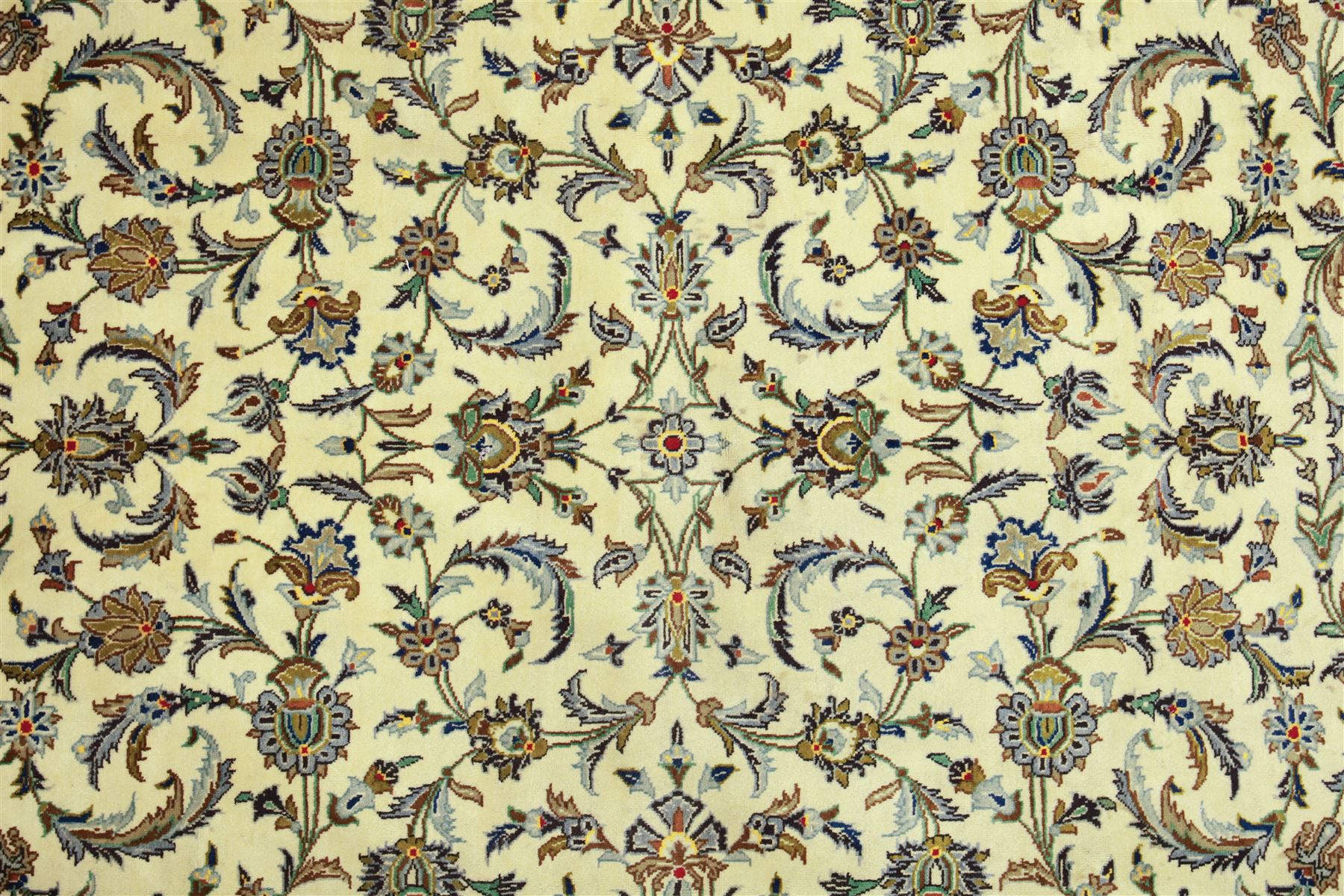 Central Persian Kashan carpet, ivory ground, field with an all-over design of scrolling palmettes and floral sprays in blue and terracotta within a beige ground and pale blue floral border