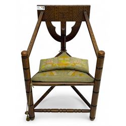 19th century swedish monk's chair, the oak frame with triangular seat and sloped arms, the...