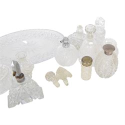 Collection of cut glass scent bottles including Art Deco examples and a cut glass tray