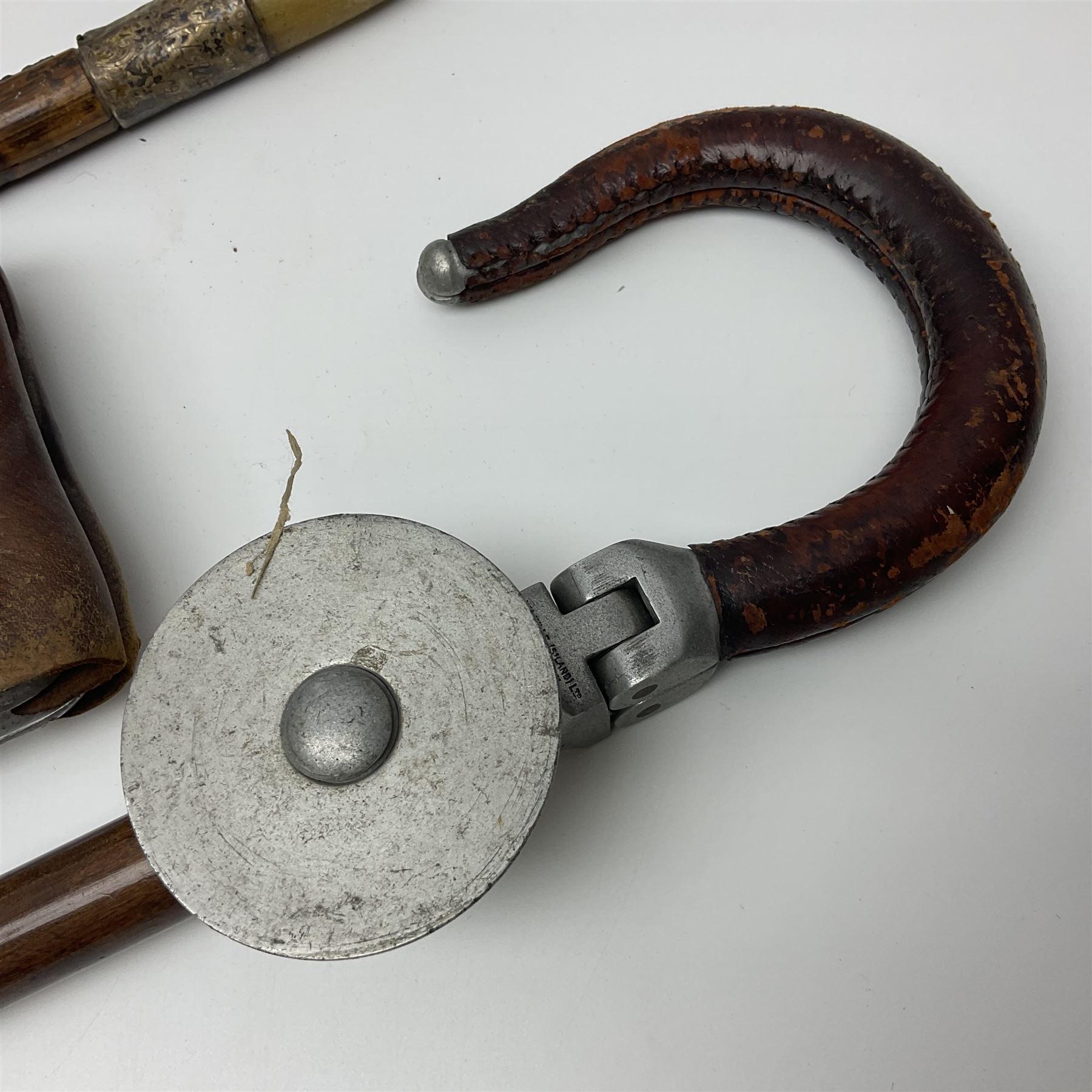 Early 20th century curved horn handle walking stick with hallmarked silver mounts, engraved L Russell 1918, together with a shooting stick by William Mills Birmingham, with leather handle, 'The Featherwaite' shooting stick and an umbrella with wooden handle