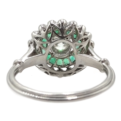 Platinum round diamond and calibre cut emerald target design ring, with diamond set shoulders