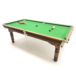 20th century mahogany framed billiard/dining table, rise and fall mechanism, four mahogany leaves, with accessories including scoreboard, balls, cues etc, W227cm, D121cm, H71cm (lowest)
