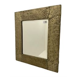 Early 20th century Arts & Crafts bevelled wall mirror, in hammered and tooled metal frame with nail or stud work detail