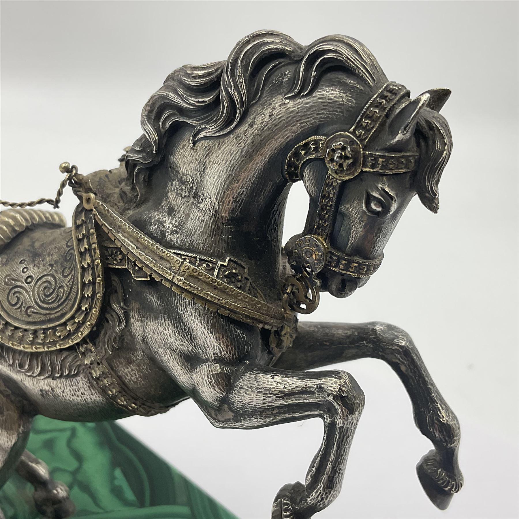 Modern silver model of a rearing horse, with ornate parcel gilt saddle and bridle, mounted upon a rectangular base, decorated with malachite panels to each side and upon four gilt bun feet, horse stamped 925, overall H14.5cm