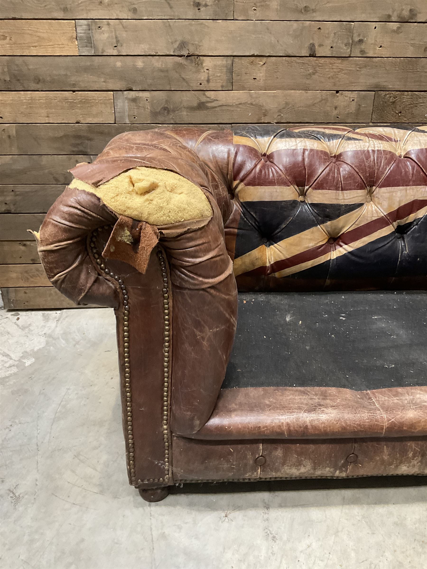 Chesterfield two sofa upholstered in brown leather, with Union Jack pattern, no seat cushions - located in storage, viewing not available
