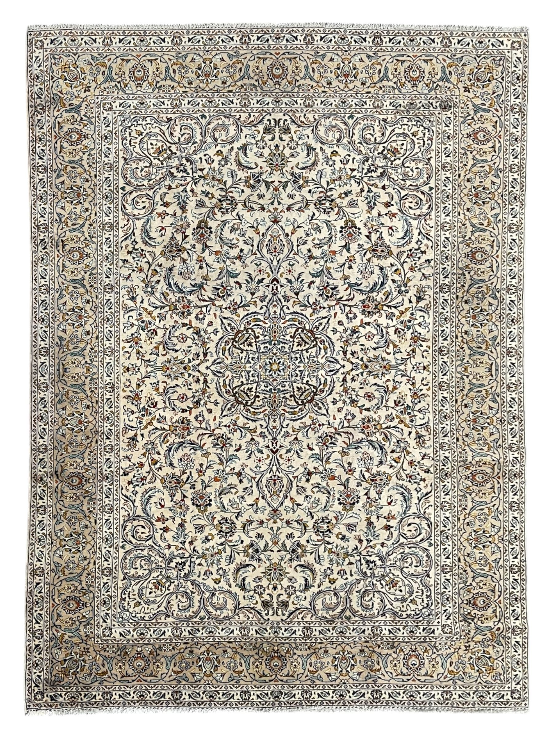 Persian Kashan ivory ground carpet, central pole medallion surrounded by swirling leafy branches and stylised plant motifs, scrolled foliate spandrels, the main border decorated with scrolling pattern and repeating palmettes, within floral patter guard stripes 