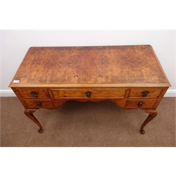  Mid 20th century figured walnut desk/dressing table, five drawers, shaped apron, cabriole legs, W113cm, H77cm, D52cm  