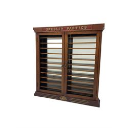 Modern hardwood display cabinet for model railway locomotives inscribed 'Gresley Pacifics' to the frieze and 'LNER' to the bottom rail; with mirrored back and ten loose fitting shelves enclosed by a pair of unglazed doors L101cm H108cm D16cm