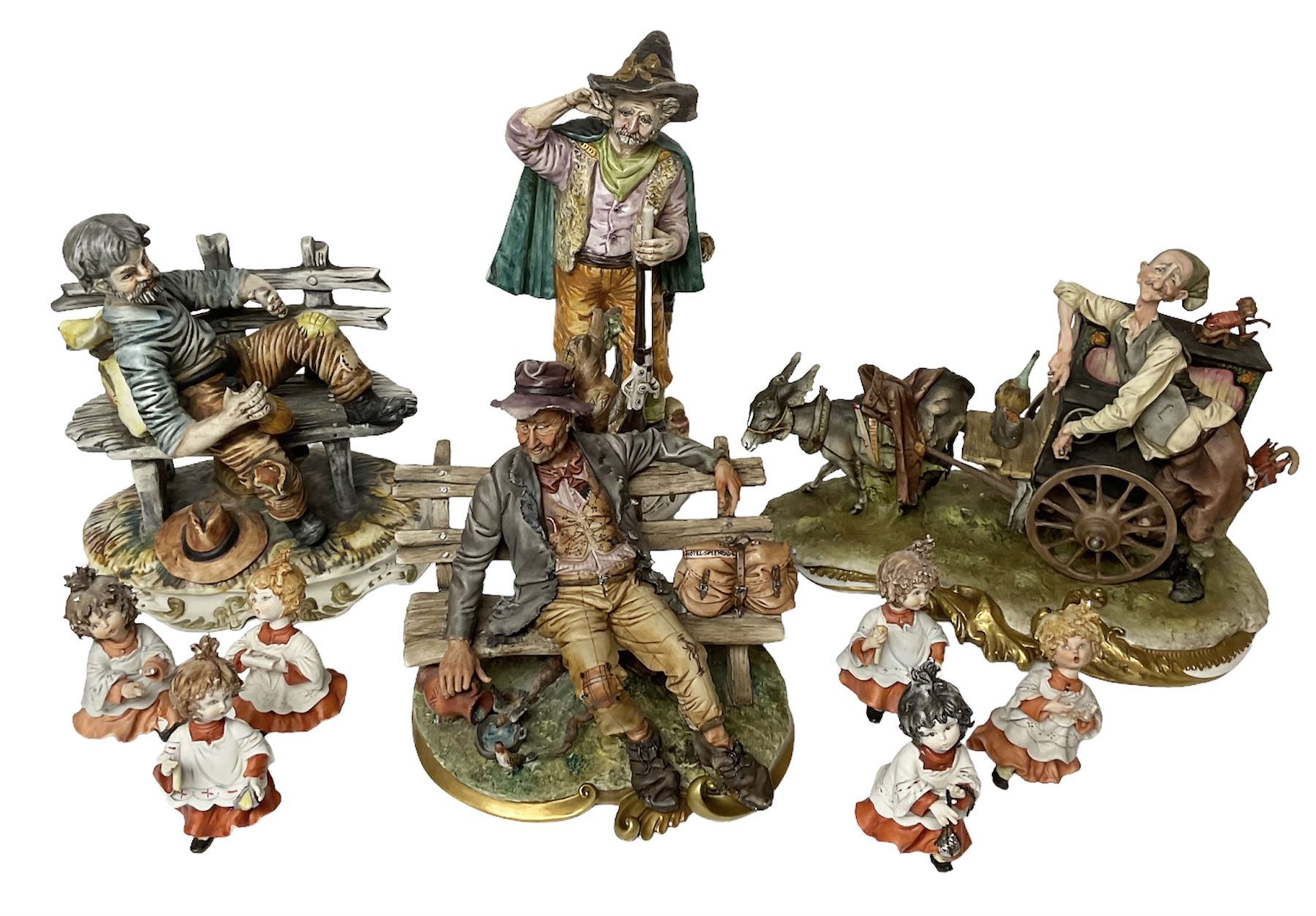 Group of Capodimonte figures, to include musical organ grinder with donkey and monkey, two tramp figures on benches, man with gun and choir boy and girl figures