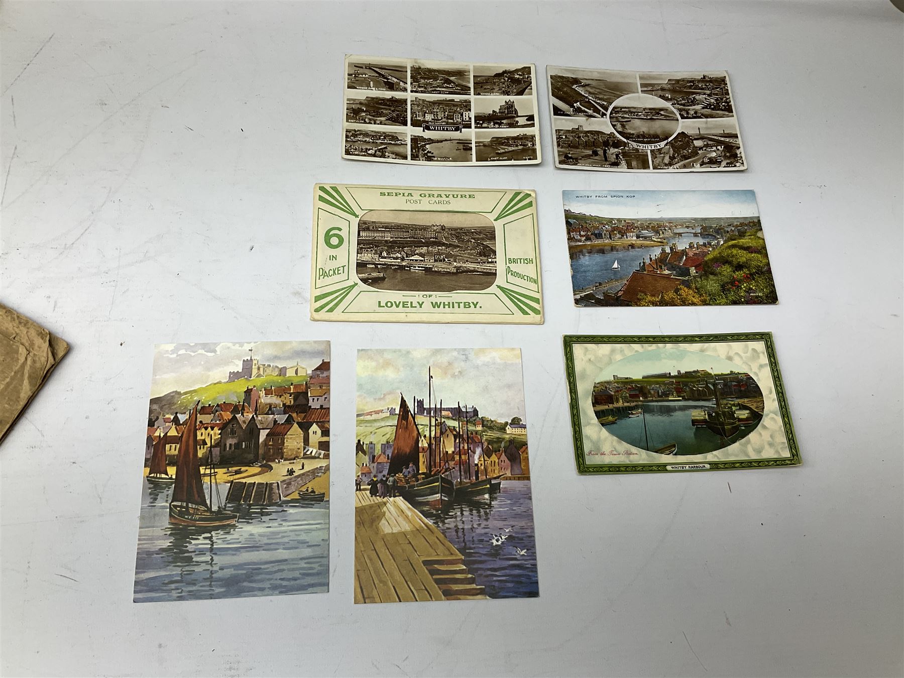 Quantity of books and postcards predominantly of Whitby interest including Hornes' Guide to Whitby 1890 and Hornes' Tourist map of Whitby, A Holiday Tour in and Around Whitby by H.S. Forman 1896 etc