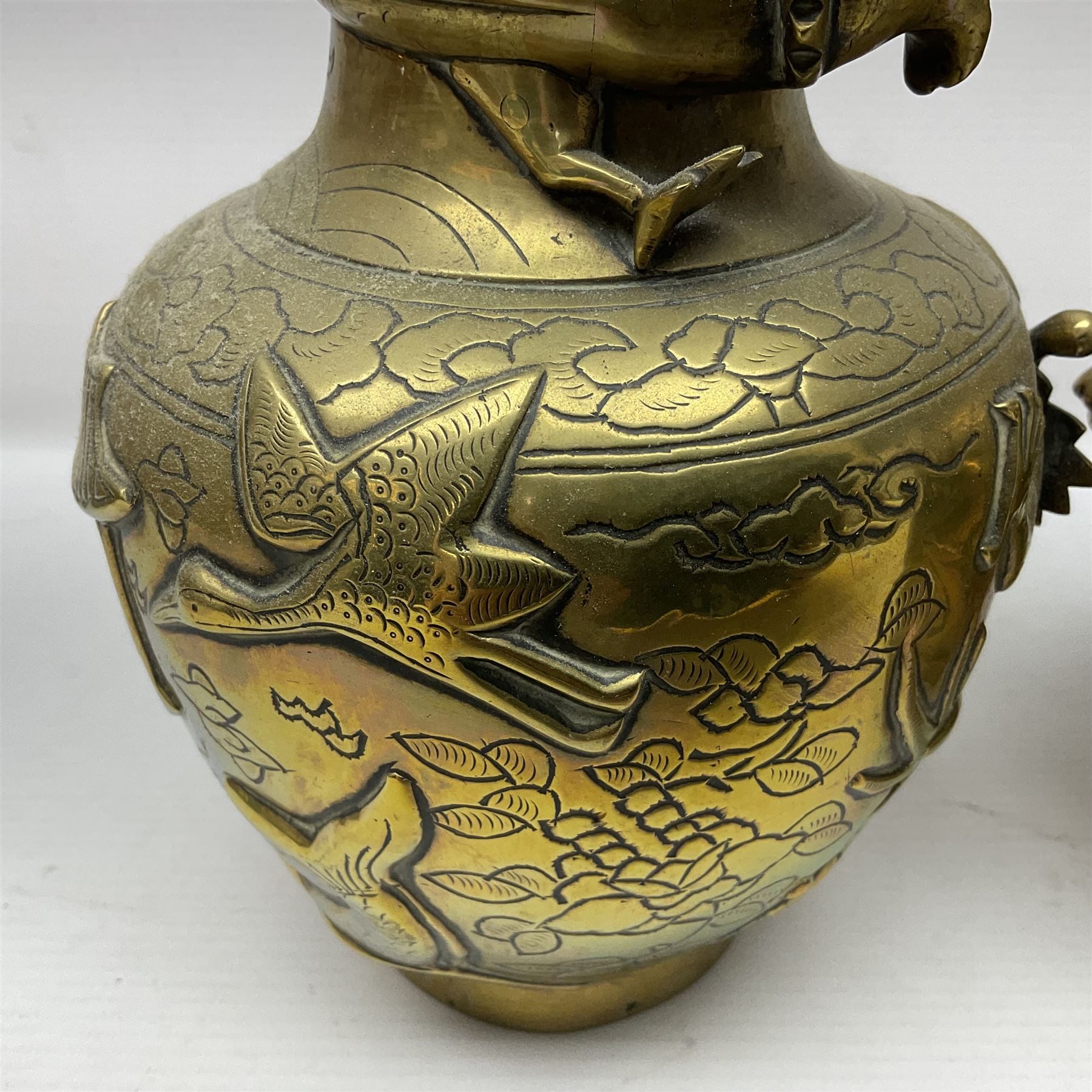 Pair of Chinese brass vases, of ovoid form with elongated neck and fluted rim, decorated in high relief with a dragon chasing a flaming pearl around the neck, the body with dragons, birds and buildings, with character marks beneath, H25cm