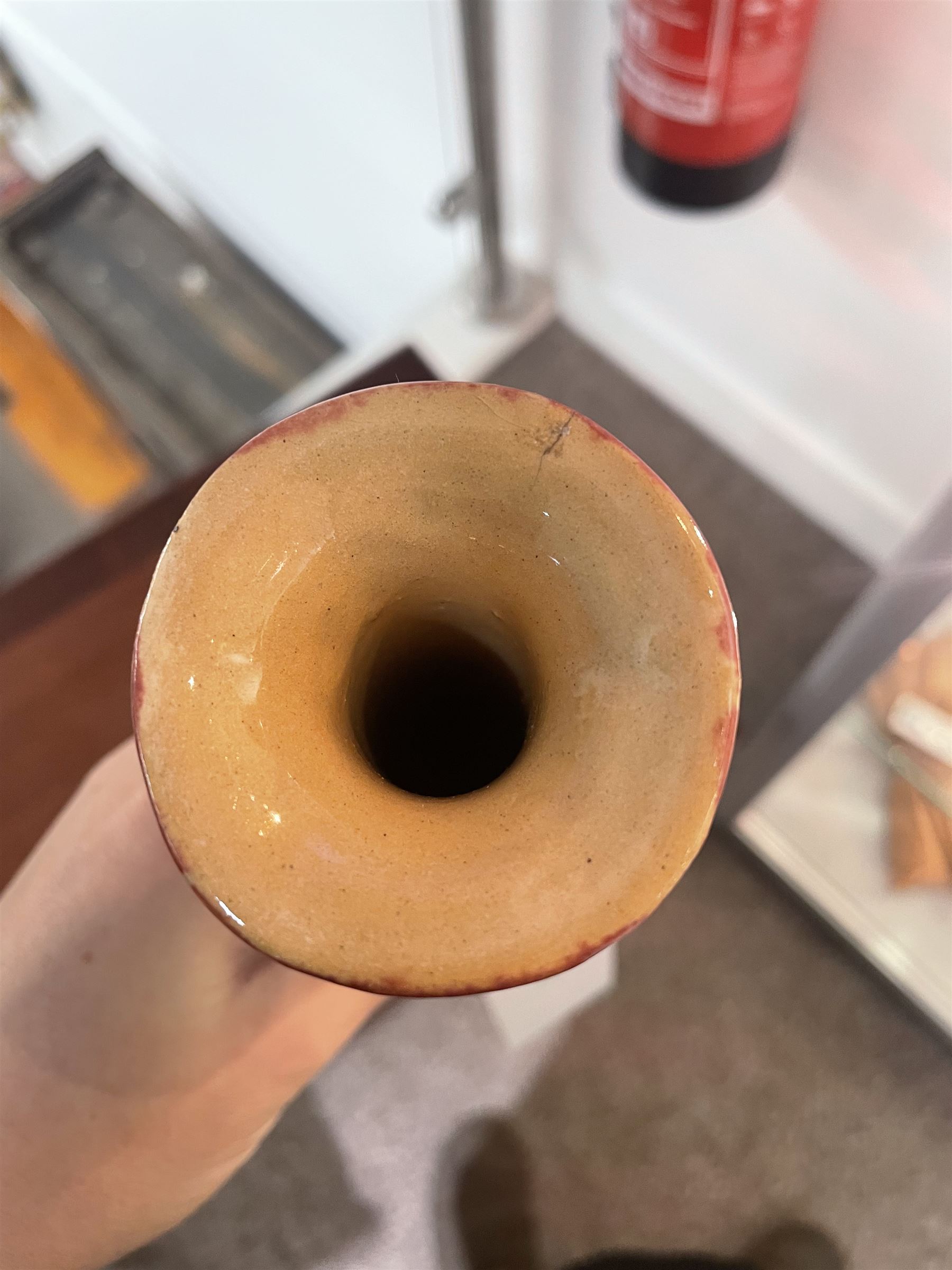 Early 20th century Jugenstijl vase by Aardewerkfabriek De Kat, Bergen op Zoom Pottery (1902-1918) attributed to Chris van der Hoef, of angular form with elongated tapering neck with flared rim, in pinkish red glaze with cross motif to the body, impressed marks beneath, H31cm