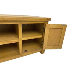 Light oak TV or media cabinet, rectangular top over single open shelf flanked by two cupboards