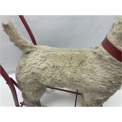 Tri ang - Pedigree Soft Toys - push along/ride-on dog as a wood wool filled plush Airedale terrier in red tubular frame with beech footrests and black rubber wheels; stitched Northern Ireland label in tact L60cm H61cm