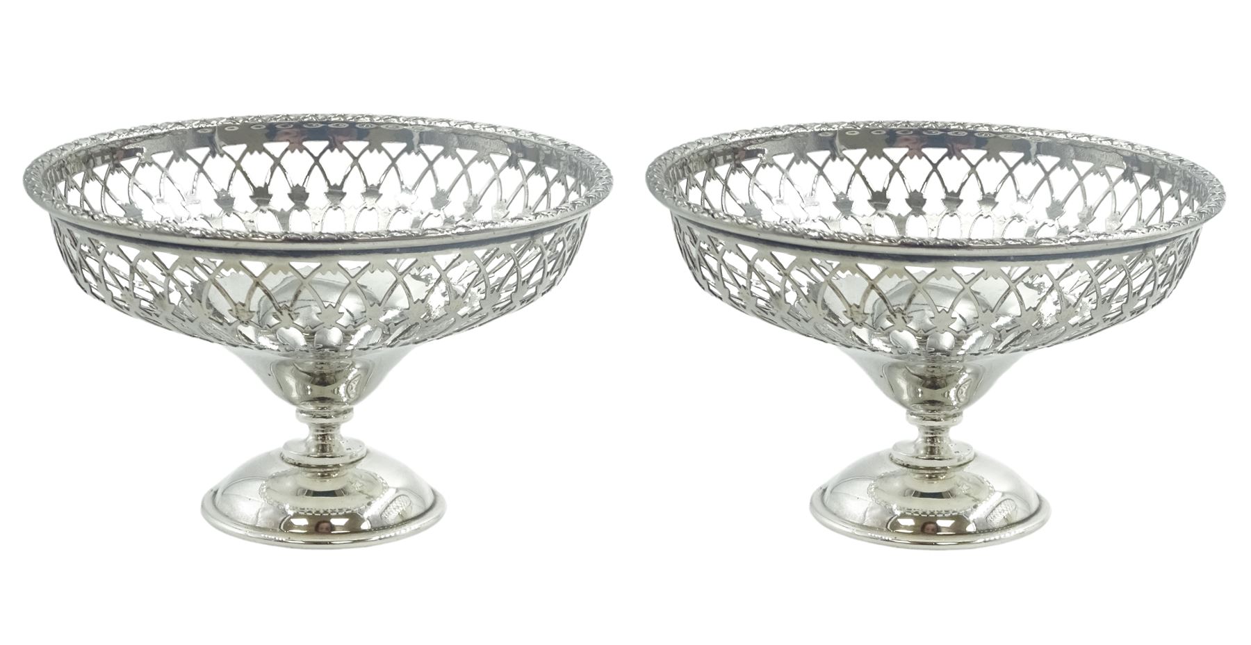 Pair of early 20th century small silver openwork footed bowls, of part pierced circular form upon domed circular feet, hallmarked Walker & Hall, Sheffield 1906 and 1912, H5.5cm D9.5cm, approximate total weight 3.18 ozt (99 grams)