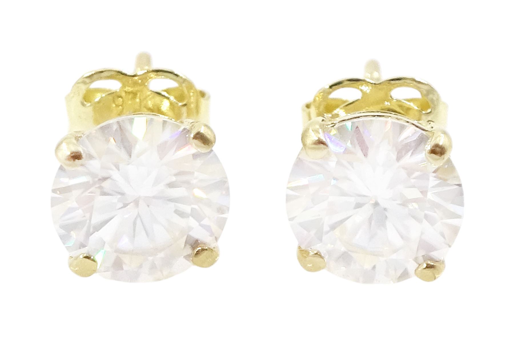 Pair of 9ct gold moissanite earrings, each stud set with a single round brilliant cut moissanite