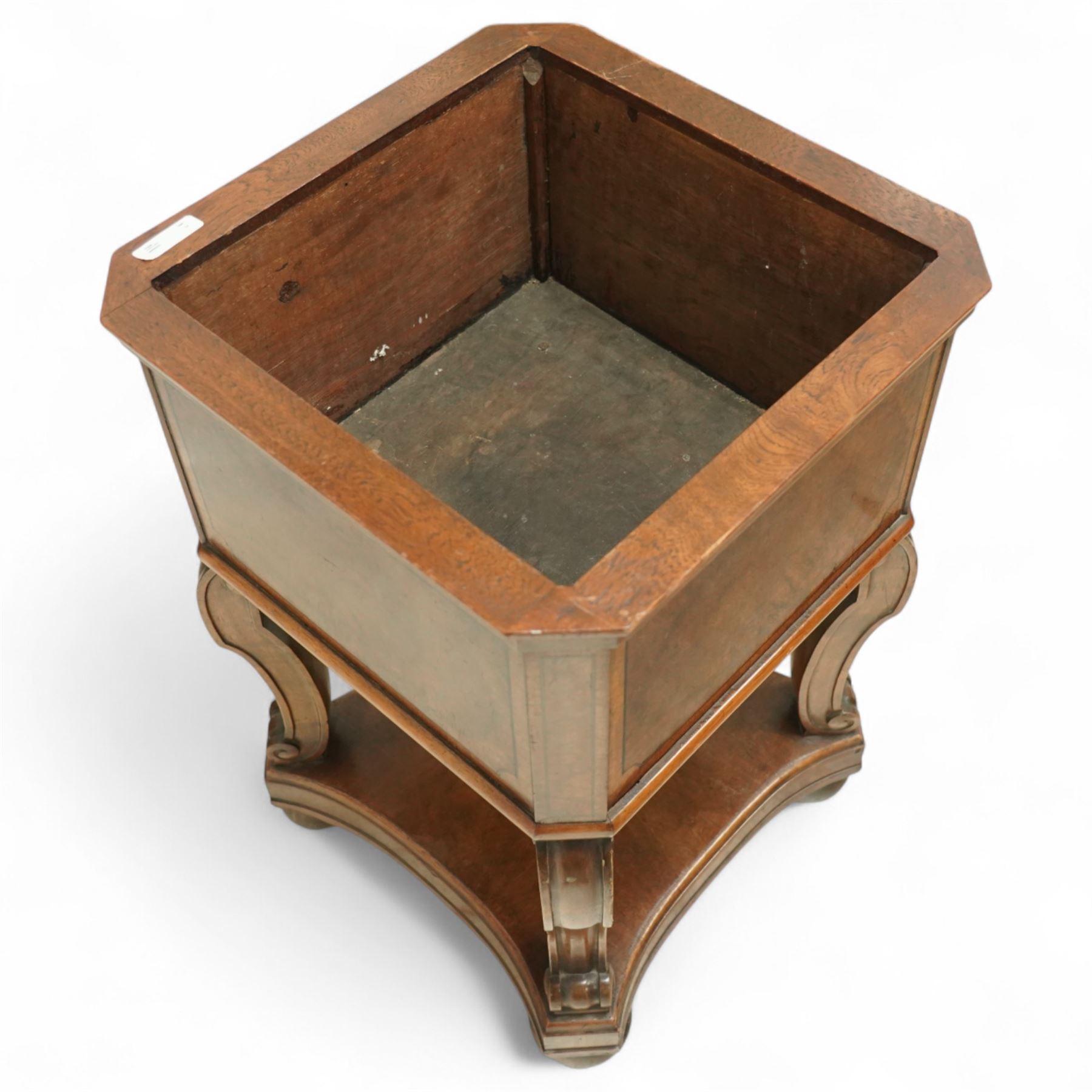 Edwardian style walnut jardiniere stand, of square form, with burr walnut veneered side panels on scroll carved supports on a shaped plinth base 