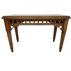 Late 19th century oak ecclesiastical side table, the rectangular top with canted corners, pierced arcade frieze with carved and pierced trefoil decoration, on turned and reeded supports