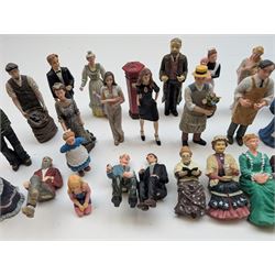 1:12 scale dolls house composite figures, including policeman, postman, maid, sitting and standing people in various styles of dress, etc