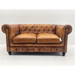 Two seat Chesterfield sofa upholstered in antique finish tan buttoned leather