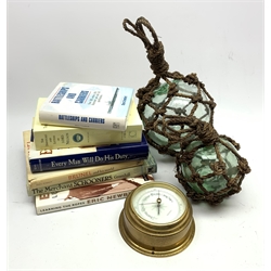 Two rope bound spherical glass floats, Acctim ship's style brass cased bulk head barometer and six books of nautical interest including Every man Will Do His Duty by Dean King 1998
