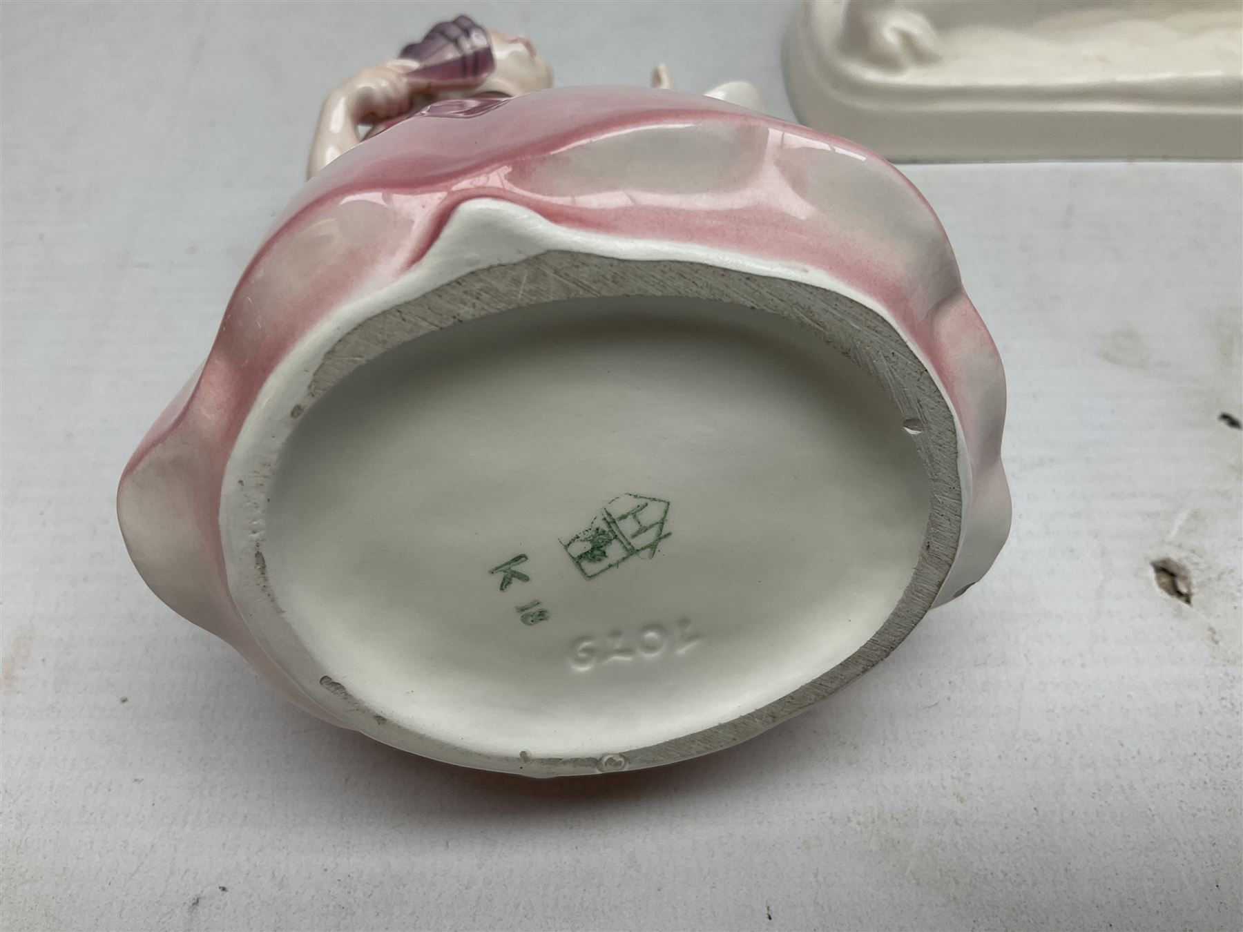 Early 20th century Katzhütte figure of a pointer dog, and figure of a young girl holding basket and fan, both with green cat H house printed mark beneath, dog L25cm