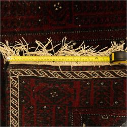 Three rugs,  comprising a Baluch rug in crimson ground, 179x97cm, a Tekke Bokhara rug in crimson ground, 201x132cm, and a Bokhara rug in ochre ground, 125x175cm 