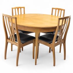 Sutcliffe of Todmorden - mid 20th century ‘S-Form’ teak dining table and chairs, the circular storable extending table with plain veneered top on tapered supports, together with matching dining chairs upholstered in black vinyl, with curved slat backs and shaped front supports, reflecting the sleek organic styling characteristic of 1960s British modern furniture design (Chairs H 93cm, W 46cm, D 46cm) (Extended 168cm)