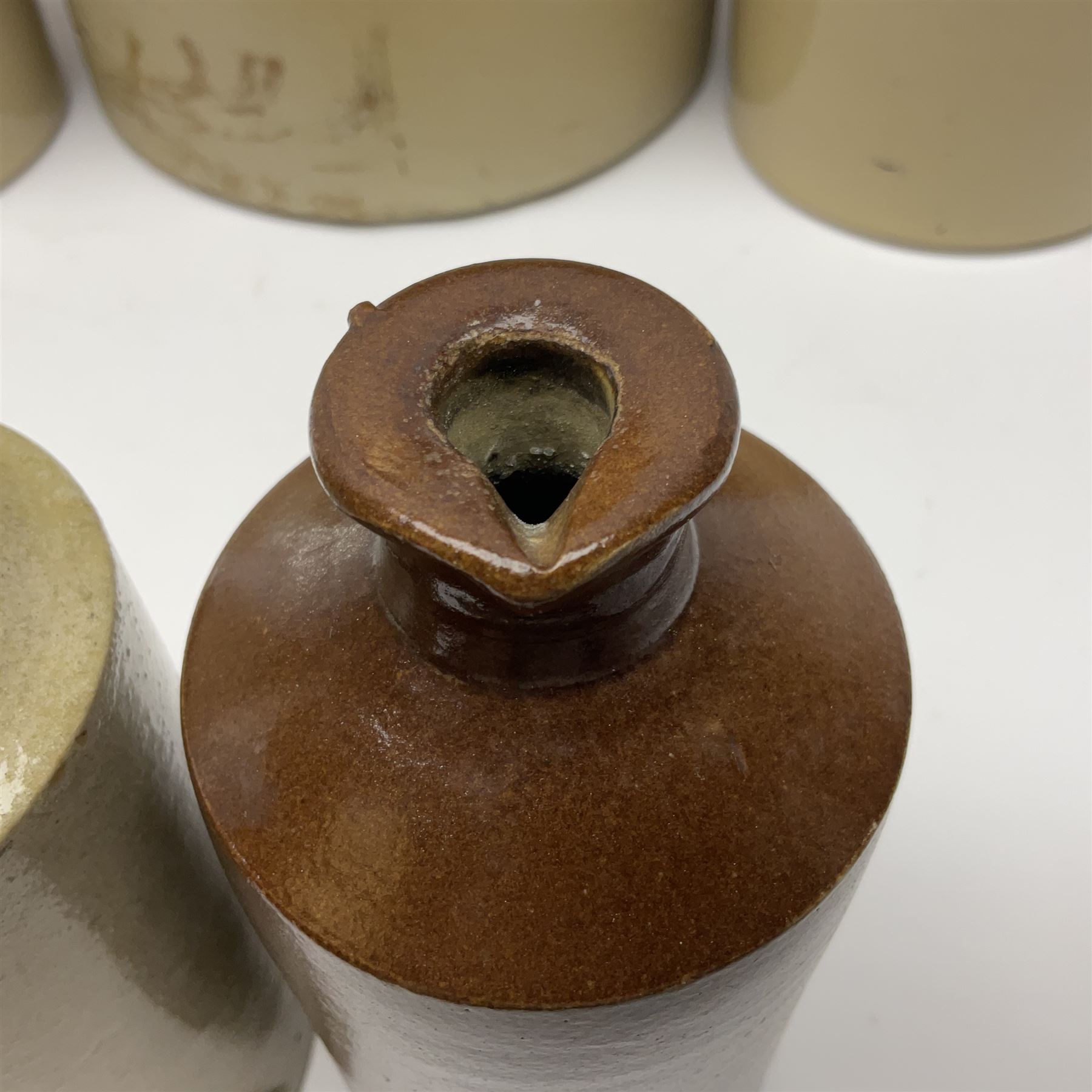 Large 2 gallon stoneware flagon, stamped 'John Soulby Wine Merchant Malton 2 Gall', together with a collection of similar stoneware jars and bottles, largest H40.5cm