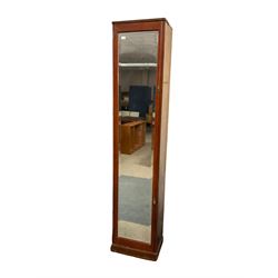Early 20th century walnut cupboard, fitted with single door with rectangular bevelled mirror plate, on plinth base