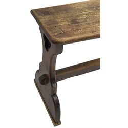 Late Victorian ecclesiastical pitch pine side table, rectangular bow-front top, on shaped end supports pierced with quatrefoils, united by pegged stretcher 