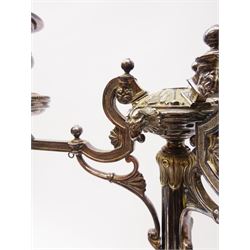 A large Victorian Thomas Bradbury & Sons silver plated candelabrum, the circular base with flower head border upon three domed feet, supporting a central knopped and fluted column flanked by three zoomorphic creatures, leading to a central socket with removable nozzle above a large palmette detailed drip pan, and three scrolling branches with conforming sockets and nozzles, with maker's silver plate mark and Victorian registration lozenge beneath, H62.5cm