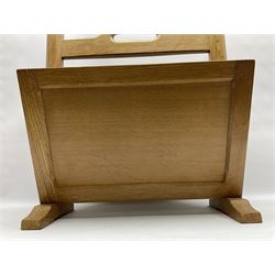 Mouseman - oak magazine rack, the top rail pierced with handle and carved with mouse signature, octagonal supports with two panelled and splayed sides, on sledge feet, by the workshop of Robert Thompson, Kilburn 