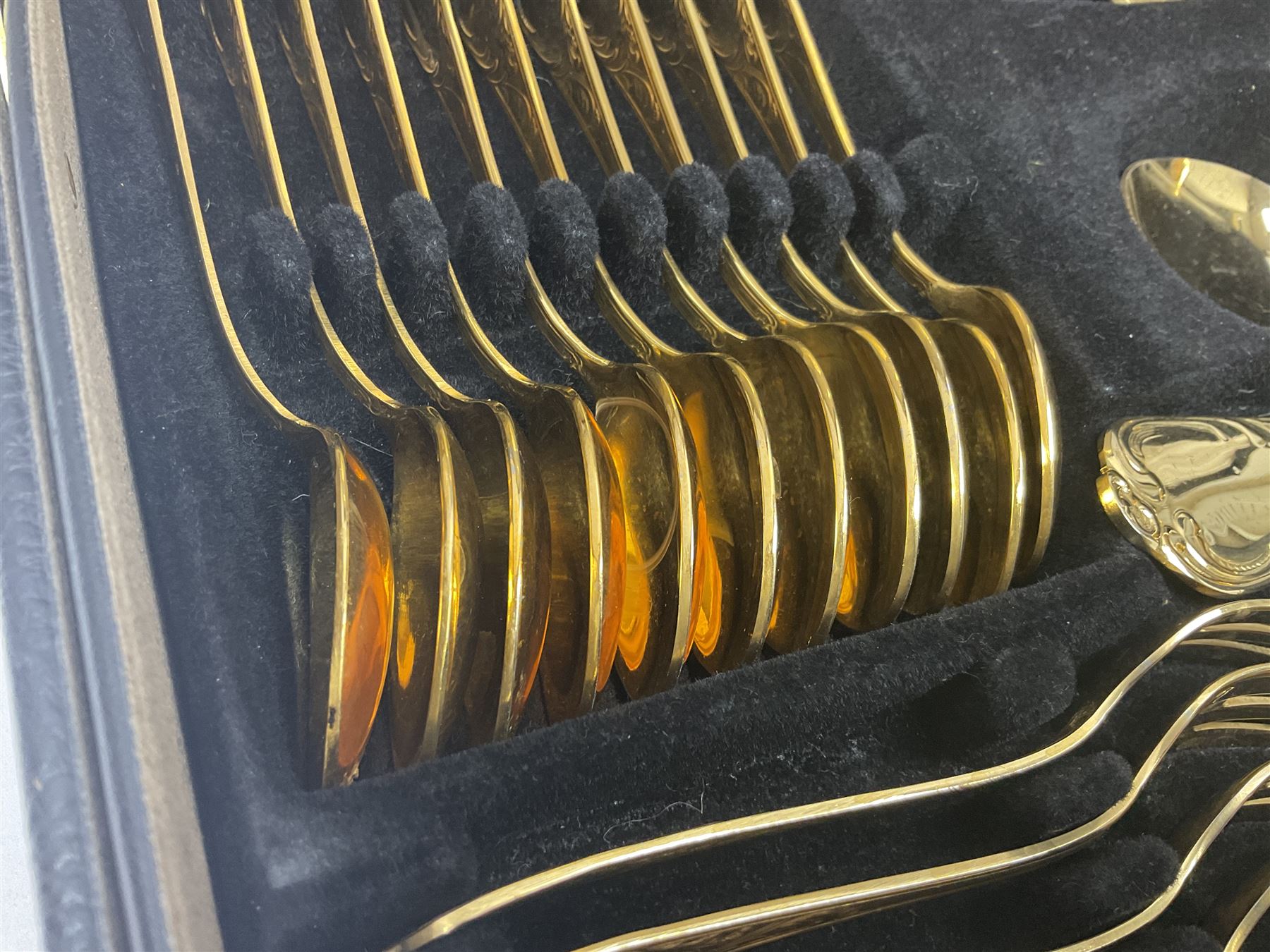 Bestecke Solingen canteen of gold plated cutlery for twelve place settings, including ladle, cake slice and serving spoons, contained within a briefcase, together with a matching set twelve of Bestecke Solingen gold plated fish knives and forks, in fitted case 