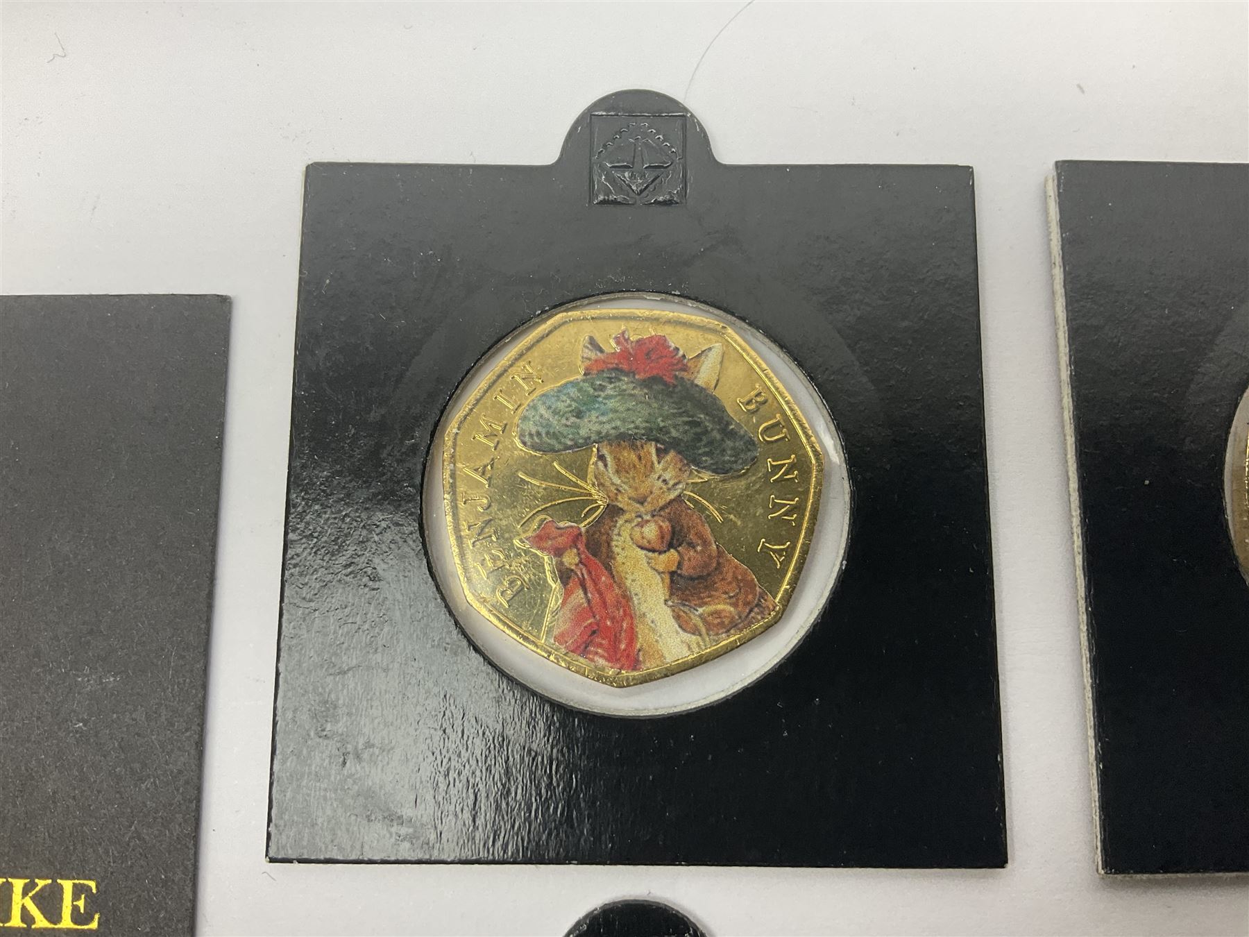 Four gold plated and coloured commemorative fifty pence coins, comprising 2017 Benjamin Bunny, Mr Jeremy Fisher, Tom Kitten and The Tale of Peter Rabbit, with Gold Strike certificate of authenticity