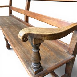 Early 20th century pine and oak bench seat, stained pine rail back frame with shaped oak arms
