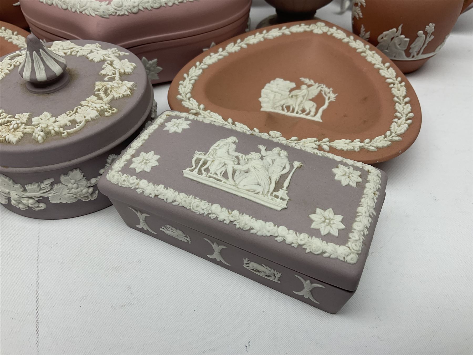 Collection of Wedgwood Jasperware, in orange, lilac and pink colourways, including oval tray, small jug, trinket boxes, trinket dishes, etc , all with impressed mark beneath